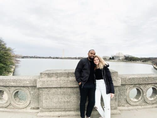 interracial couple poses at Tidal Basin in Washington D.C.