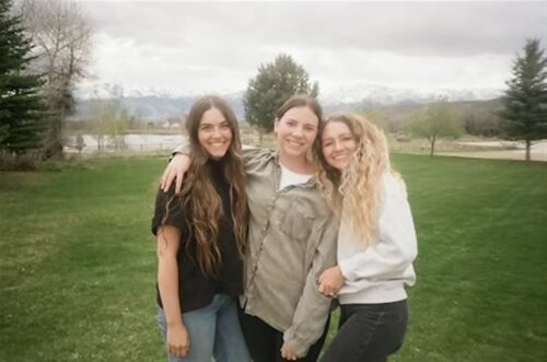 three female employees posing outdoors in winter