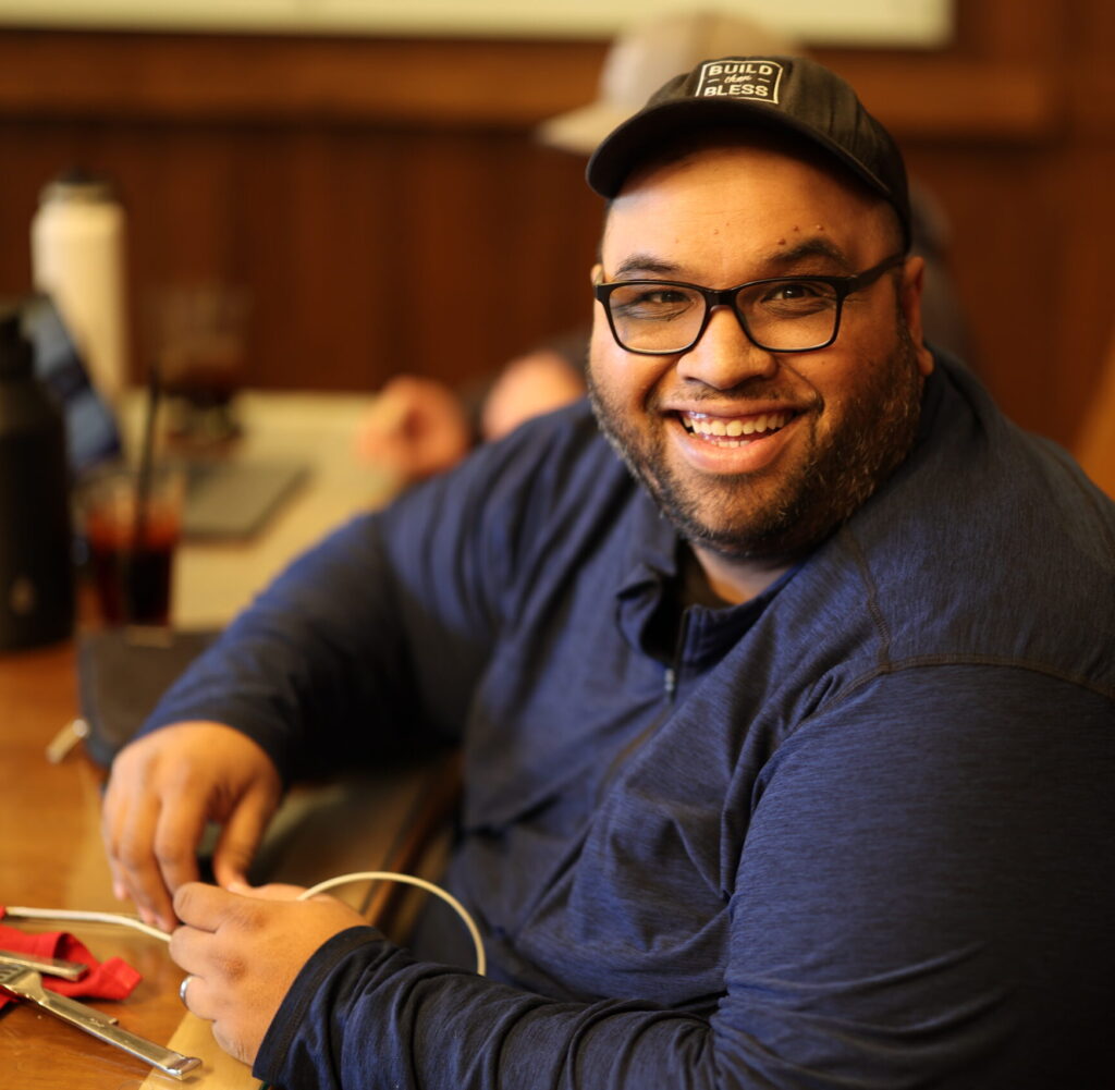 John Rowa smiling in a build then bless hat