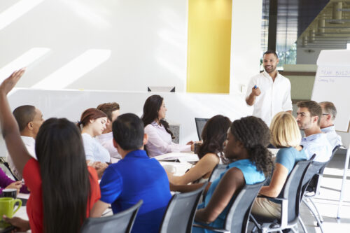 employees in conference room brainstorm team building ideas