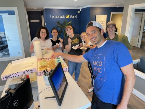 lemonade stand employees eating cookies