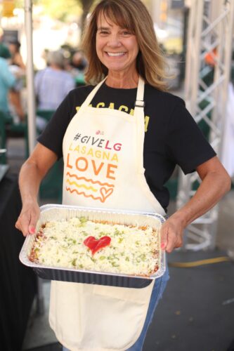 Woman holds homemade lasagna