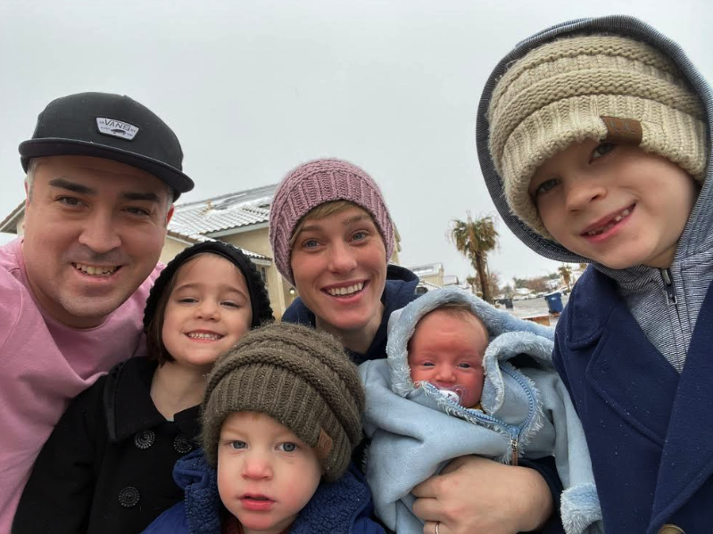 mother and father take selfie with their four children